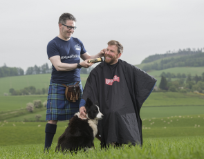 RSABI #KeepTalking ambassador Jim Smith is pictured receiving a pre Royal Highland Show tidy up with some golden Wahl clippers by the Kilted Barber, Campbell Ewen.