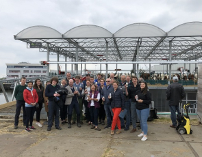 Group photo of Learning Journey participants outside floating dairy