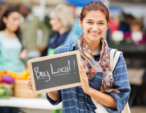 Woman holding buy local sign
