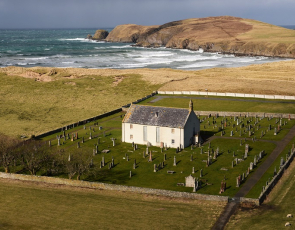 Church and churchyard with sea and cliffs