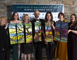 The winners holding their 7 piece work of textile art from artist Jo Gallant. Photo credit: Mike Bolam 
