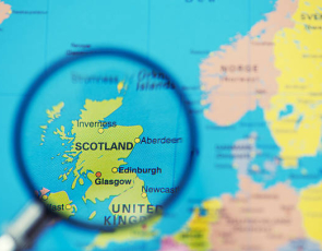 Magnifying glass over map of Scotland