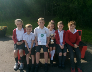 pupils from the P2/3 class accepting the cup, certificate and £50 book token