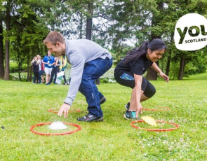 young people playing game with Youth Scotland graphic