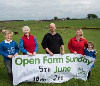 People holding an Open Farm Sunday banner