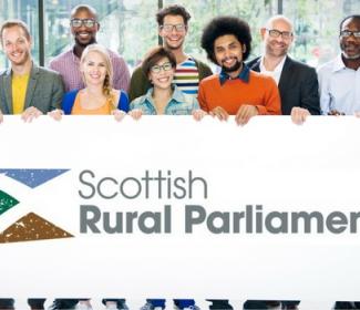 Group of people 'holding' Scottish Rural Parliament logo