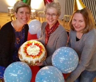 Anne Rowe, Sandra Hogg and Rhonda Mclean of Funding Scotland celebrate with a birthday cake