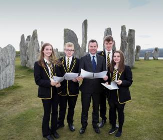 Islands Minister Derek Mackay with school pupils in front of Callanish Stones