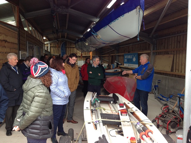 photo of people in a boatshed with boats