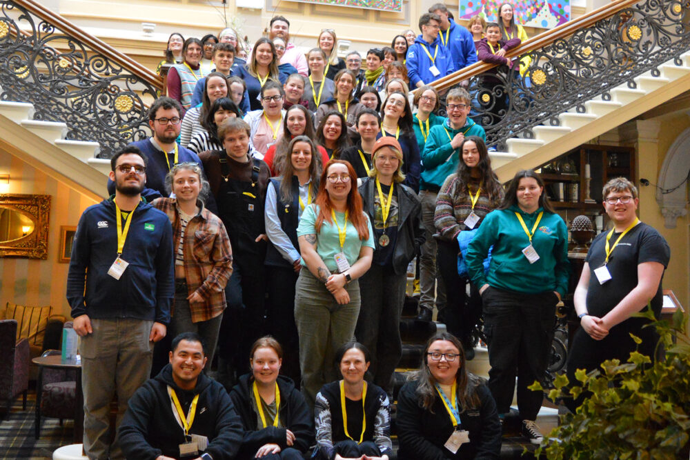 Group photo of young people sitting and standing at stairs