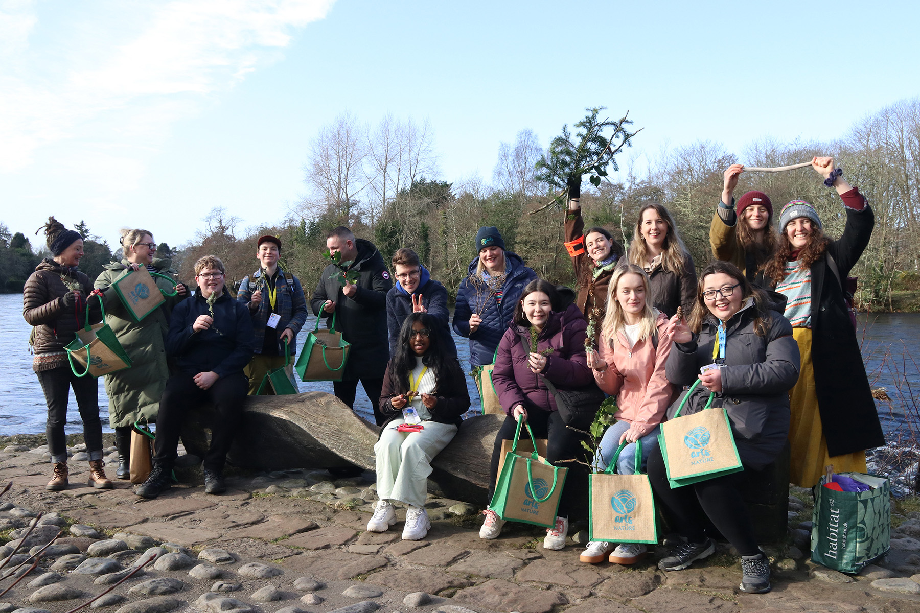 Group photo of young people standing on loch bank