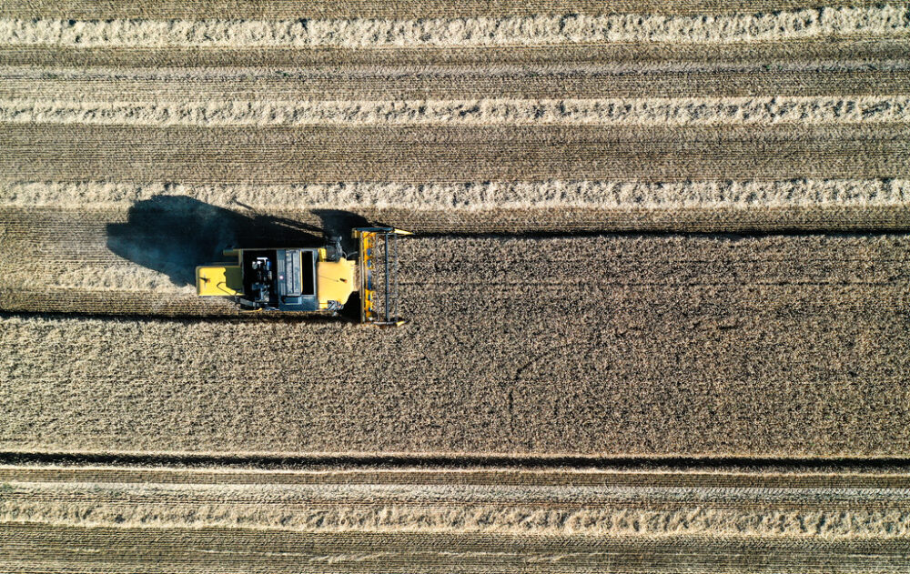 Ariel view of combine harvester at work in Scotland