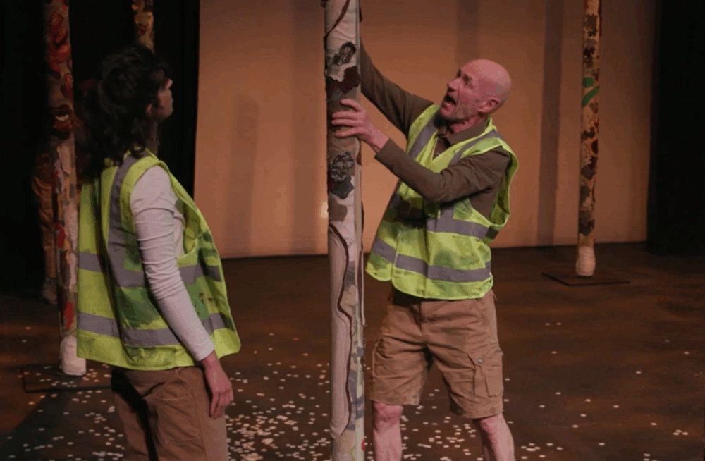 Actors dressed in hi vis vests on a forest themed film set