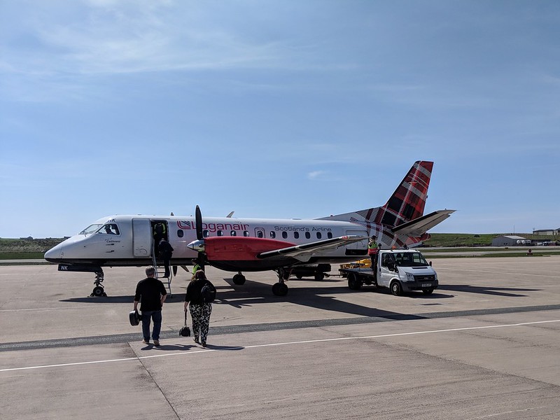 Small plane on the tarmac with passengers approaching 