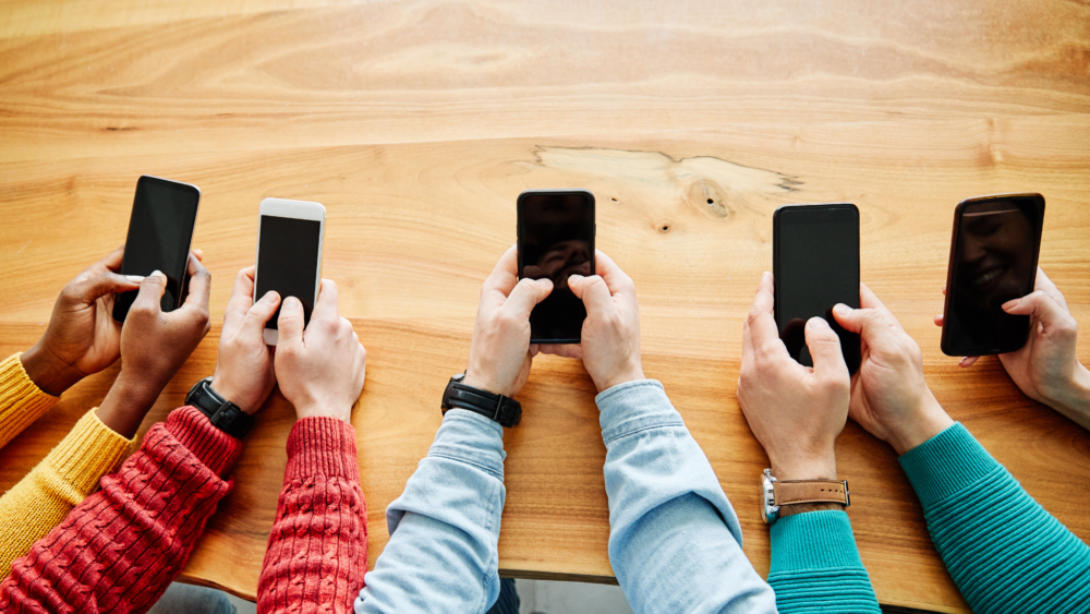 close up shot of young people using smart phones