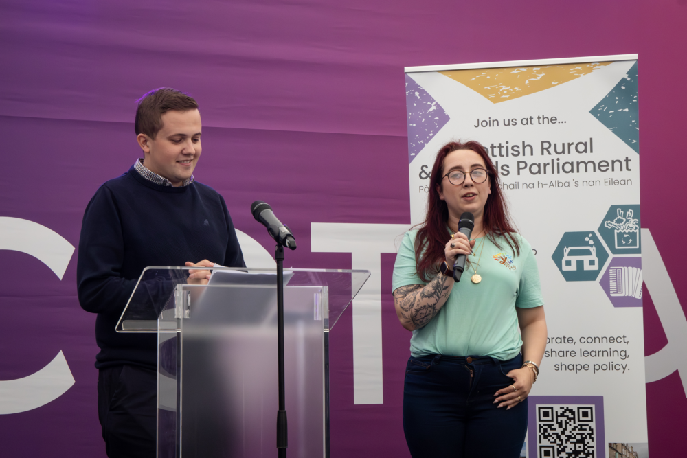 Two young speakers at a podium during the Royal Highland Show